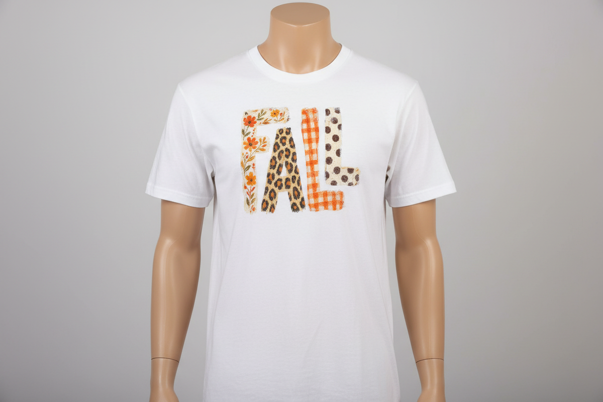 Bold FALL letters with floral, leopard, buffalo plaid, and polka dot patterns on white t-shirt on tan mannequin